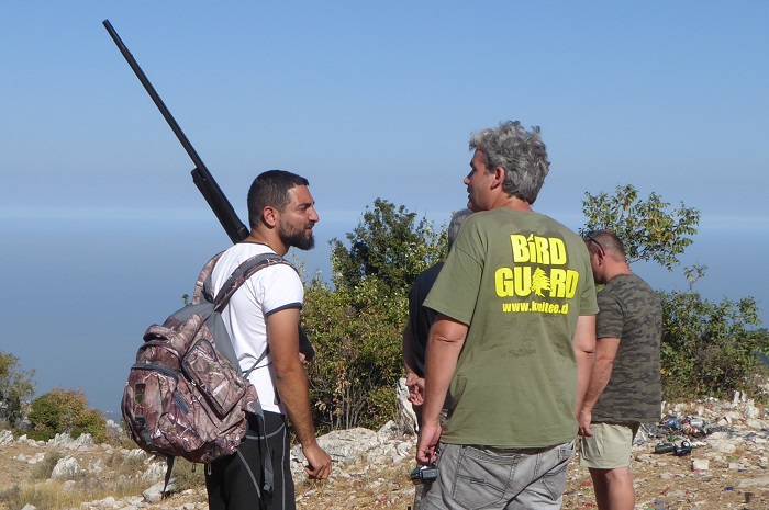 Hunter with shotgun on a Lebanese ridge