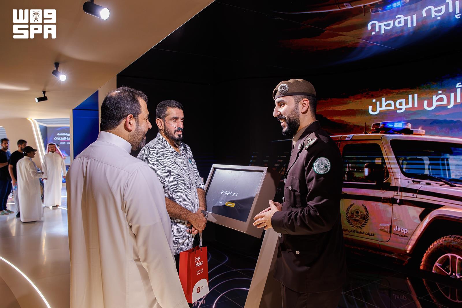 Visitors learn about displays at the Ministry of Interior pavilion.